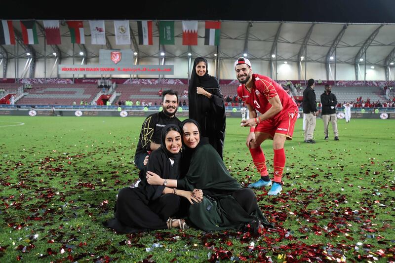 A Bahrain player and supporters celebrate on the pitch after the match. AFP