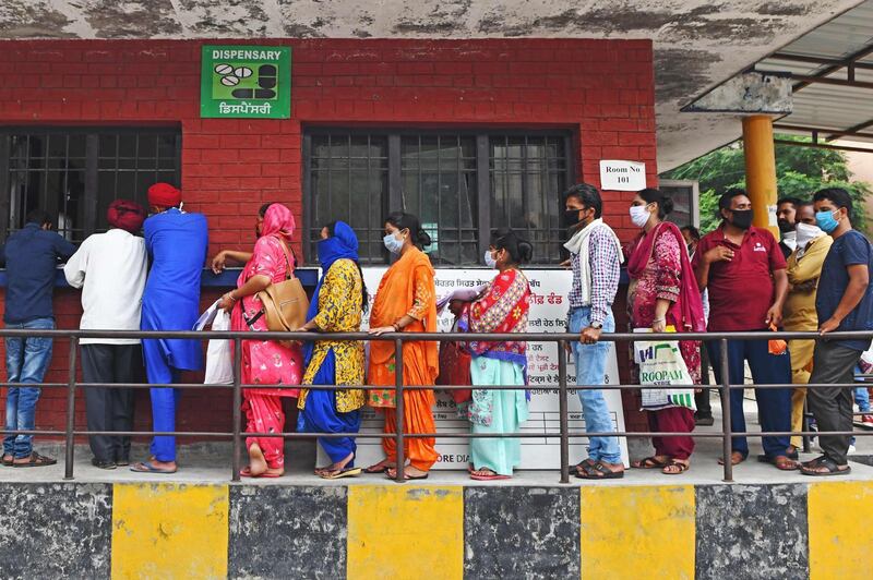 People queue to collect their Covid-19 test results at a hospital in Amritsar on July 17, 2020 as India's confirmed coronavirus cases passed one million. AFP
