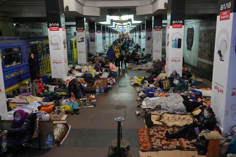 People rest with their belongings in a city subway being used as a bomb shelter in Kharkiv, Ukraine. AP