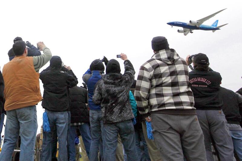 Plane spottters take pictures of the first production Boeing 787 Dreamliner take off at Paine Field in Everett, Washington in 2009. Etihad's first Dreamliner is due to arrive in the capital next month with its new 'Facets of Abu Dhabi' livery. John Froschauer / AP Photo