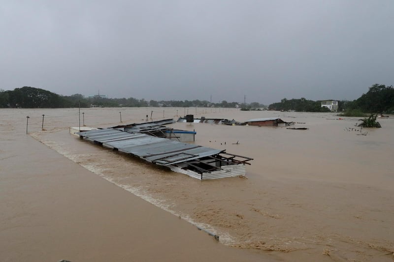 Submerged structures are seen at a swollen river as floods continue to rise in Marikina. AP Photo