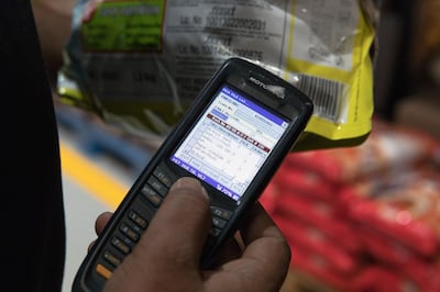 A worker scans a product while fulfilling a customer's order at a warehouse of Bigbasket, an e-grocer operated by Supermarket Grocery Supplies Pvt, in Bengaluru, India, on Monday, Feb. 26, 2018. Bangalore-based Bigbasket delivers everyday cooking essentials like ghee (clarified butter), diced coconut and fragrant basmati rice, as well as 18,000 other items from bread to laundry detergent to eight million customers in 25 Indian cities. Photographer: Samyukta Lakshmi/Bloomberg