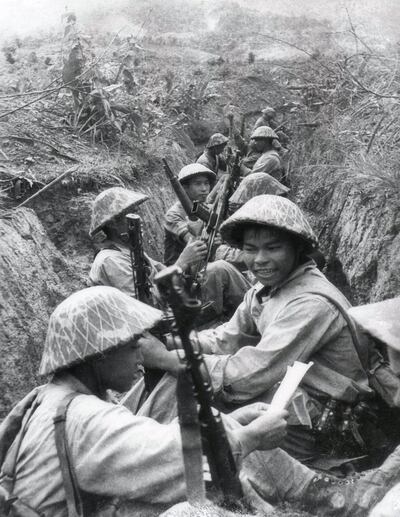 This picture taken in 1954 shows Vietnamese soldiers resting between two advances in a trench at Dien Bien Phu.  Vietnam will mark 13 March 2004 the 50th anniversary of the start of the siege of Dien Bien Phu, the epic battle that precipitated the collapse of French colonial rule in Indochina. The fighting began March 13, 1954, and 56 days later, 07 May, shell-shocked survivors of the French garnison hoisted the white flag to signal the end to one of the greatest battles of the 20th century.  EDITOR'S NOTE: THE VAST MAJORITY OF VIETNAMESE PHOTOS OF THE BATTLE ARE RECONSTRUCTIONS DONE FOR THE PURPOSE OF PROPAGANDA. MOST OF THEM WERE TAKEN JUST HOURS AFTER THE ACTUAL EVENTS DEPICTED.       AFP PHOTO/VNA/FILES (Photo by AFP / VNA FILES / AFP)