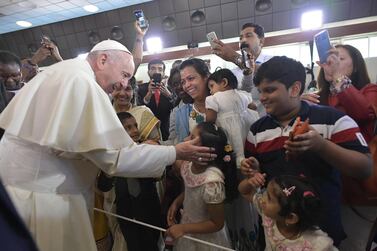 Pope Francis blesses a child during his visit to St Joseph's Cathedral in Abu Dhabi. A new church and mosque will be built in the capital in celebration of inter-faith relations in the UAE. EPA