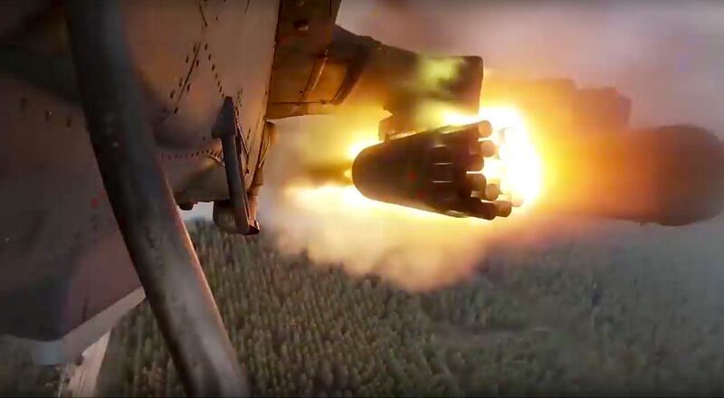 A KA-52 helicopter gunship fires rockets on a mission at an undisclosed location in Ukraine.  AP