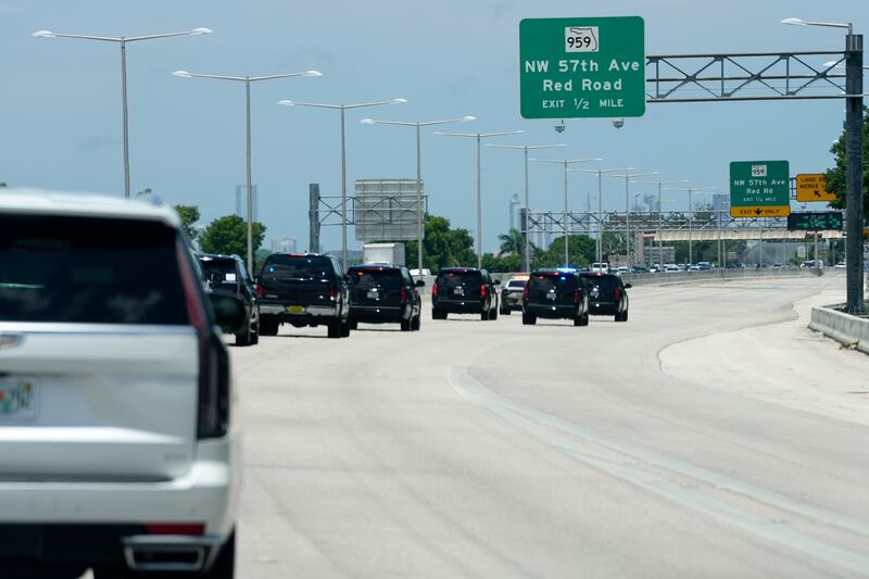 Mr Trump's motorcade drives along the Dolphin Expressway. AP