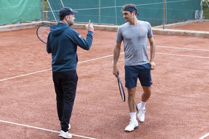 Roger Federer and coach Severin Luethi during training. EPA