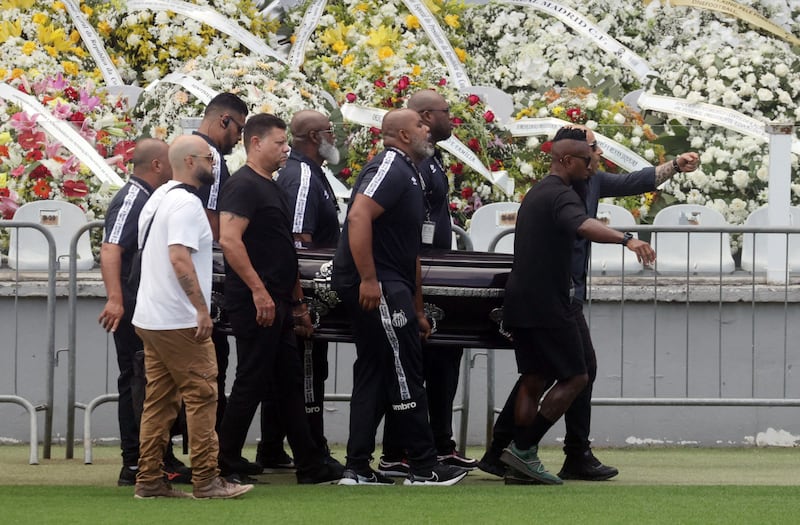 Pallbearers carry the casket of Brazilian legend Pele. Reuters