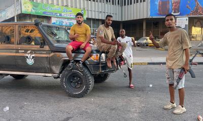 Fighters loyal to the Government of National Unity are pictured in a street in the Libyan capital. AFP