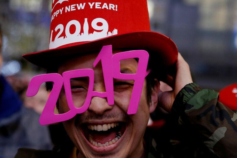 A man wears glasses shaped as the year 2019 as he attends a new year countdown event at Shibuya crossing in Tokyo, Japan, December 31, 2018. Reuters
