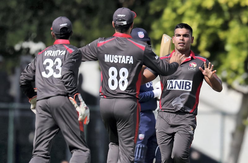 DUBAI, UNITED ARAB EMIRATES , Dec 12– 2019 :- Darius D'Silva of UAE (right) celebrating after taking the wicket of Ian Holland during the World Cup League 2 cricket match between UAE vs USA held at ICC academy in Dubai. ( Pawan Singh / The National )  For Sports. Story by Paul