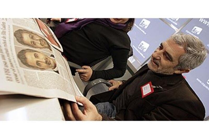 Gaspar Llamazares looks at his picture published in a newspaper next to a picture of how Osama bin Laden could look like now.