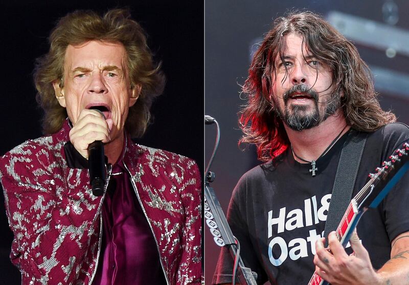 Musician Mick Jagger of The Rolling Stones performs in East Rutherford, N.J. on Aug. 1, 2019, left, Dave Grohl of the Foo Fighters performs at Pilgrimage Music and Cultural Festival in Franklin, Tenn. on Sept. 22, 2019. Jagger and Grohl have teamed up for a hard-rock pandemic anthem called â€œEazy Sleazy.â€ The duo recorded the song in different studio locations and the lyrics mention â€œprison walls,â€ â€œvirtual premieres,â€ numbers that are â€œgrimâ€ and Zoom calls. (AP Photo)