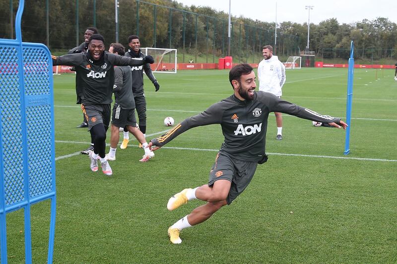 MANCHESTER, ENGLAND - OCTOBER 02: (EXCLUSIVE COVERAGE)  Timothy Fosu-Mensah and Bruno Fernandes of Manchester United in action during a first team training session at Aon Training Complex on October 02, 2020 in Manchester, England. (Photo by Matthew Peters/Manchester United via Getty Images)