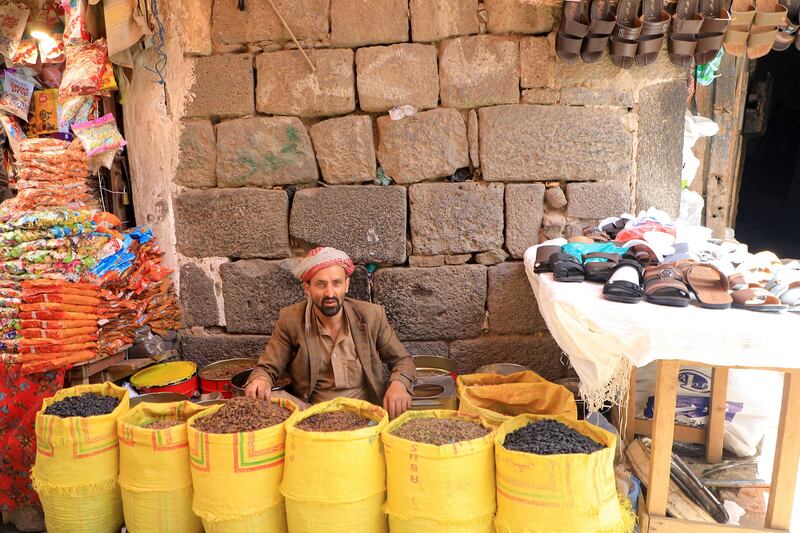 A Yemeni market trader sells dried fruit in Sanaa before Eid. AFP