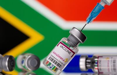 Vials labelled "Astra Zeneca COVID-19 Coronavirus Vaccine" and a syringe are seen in front of a displayed South Africa flag, in this illustration photo taken March 14, 2021. REUTERS/Dado Ruvic/Illustration