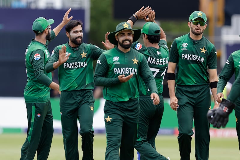 Pakistan's Mohammad Amir, second left, celebrates with teammates after the dismissal of Canada captain Saad Bin Zafar for 10. AP