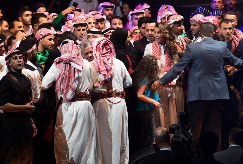 King Abdullah and Queen Rania join people on stage. EPA