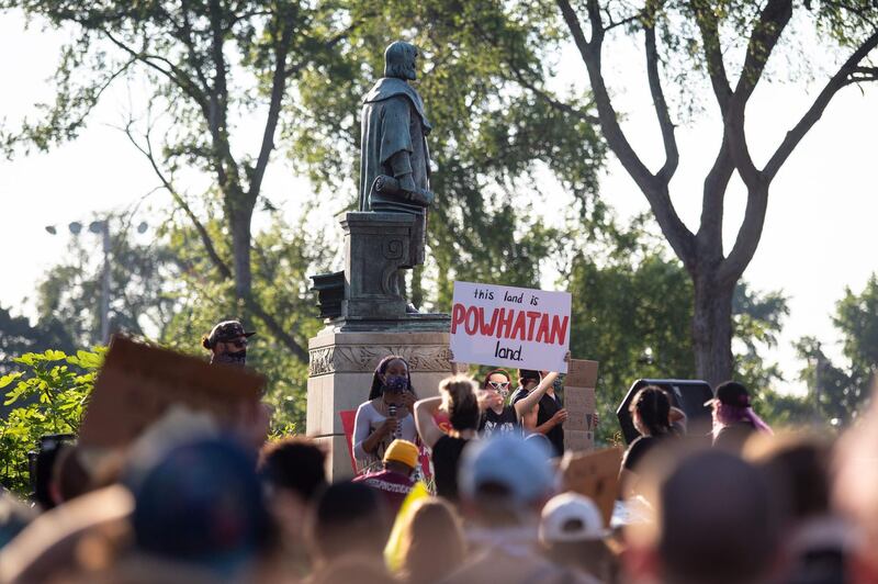 Protesters surround a statue of Christopher Columbus before marching, eventually returning and pulling it down in Richmond, Virginia. Another statue of Christopher Columbus was beheaded in Boston.  AFP