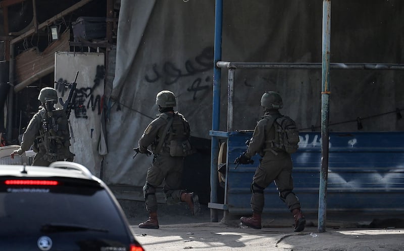 Israeli troops search the camp for relatives of a gunman from Jenin who went on a shooting spree in Tel Aviv on April 7, killing three people and wounding more than a dozen others. AFP