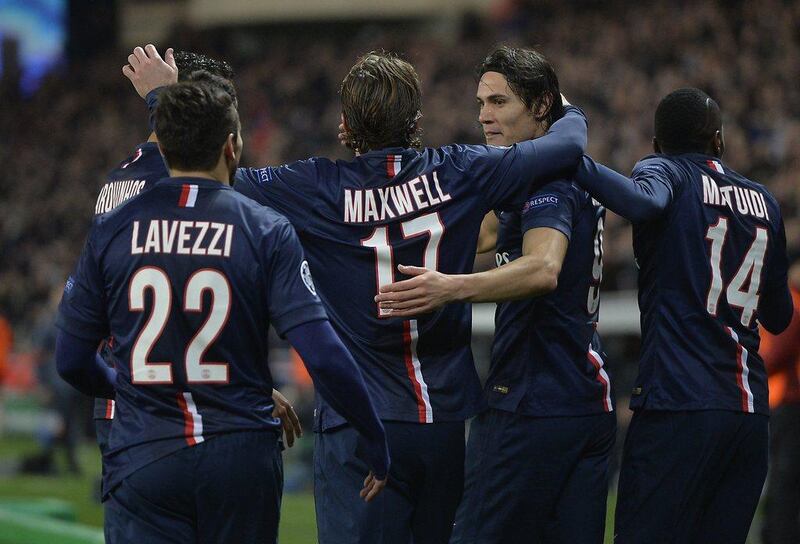 Edinson Cavani, second right, is congratulated by teammates after pulling PSG level. Miguel Medina / AFP