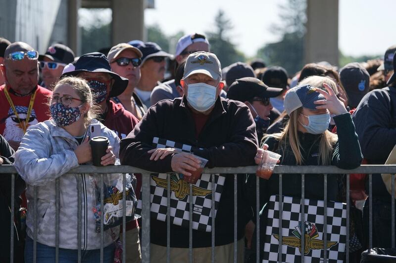 Fans stand next to Pit Row prior to the Indianapolis 500. AFP