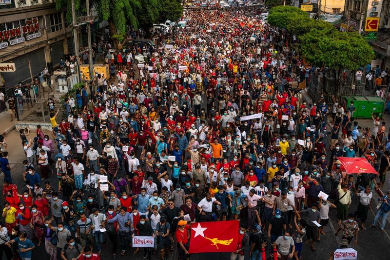 Protesters march along a street in Yangon, Myanmar. Getty Images