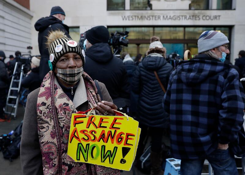 A Julian Assange supporter holds up a placard outside Westminster Magistrates Court. AP Photo