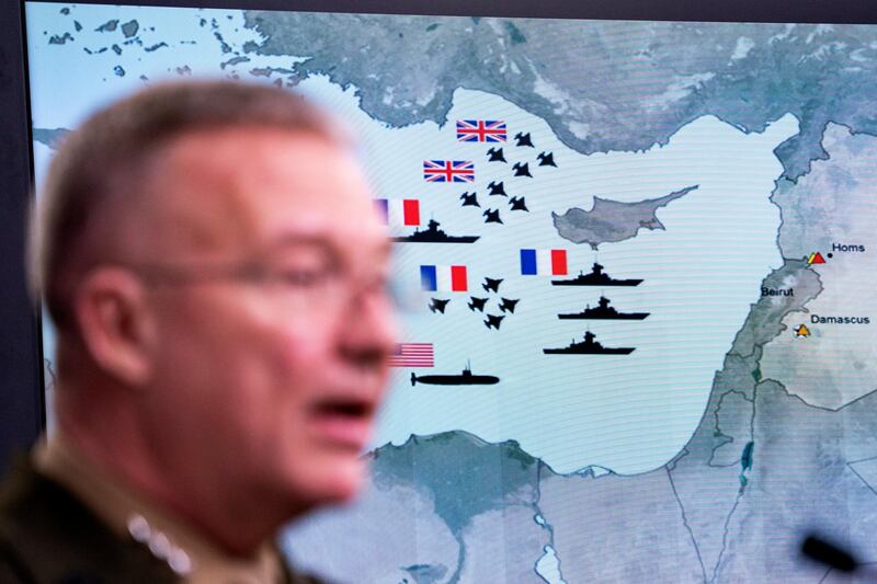 A damage assessment graphic appears behind Joint Staff director Marine Lt. Gen. Kenneth F. McKenzie Jr. as he speaks to the media about the US-led bombing campaign against Syria inside the Pentagon briefing room in Arlington, Virginia, USA, 14 April 2018. The US, France, and Britain launched strikes against Syria early Saturday morning in response to Syria's suspected chemical weapons attack.  EPA / JIM LO SCALZO