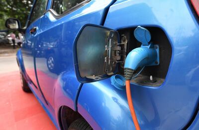 This photo taken on July 21, 2017 shows Mahindra's electric car "e2o Plus" plugged in for charging at a showroom in New Delhi.
India will roll out nearly 100,000 battery-powered buses and autorickshaws onto its sulpherous, clogged city streets in coming weeks to set it on the road to make new vehicle sales all-electric by 2030. India, one of the world's most polluted nations, has one of the most ambitious plans to kick its fossil fuel addiction. Analysts say the target is "daunting".
 / AFP PHOTO / Prakash SINGH / TO GO WITH: India-automobile-pollution-technology, FOCUS by Megha BAHREE