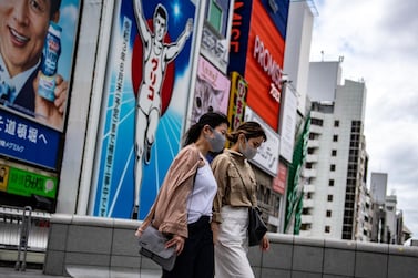The Dotonbori area of Osaka, Japan. Researchers say some East Asian populations may have traces of a type of coronavirus in their genetic make-up, but it is not thought to provide natural protection to today's novel coronavirus. Philip Fong / AFP