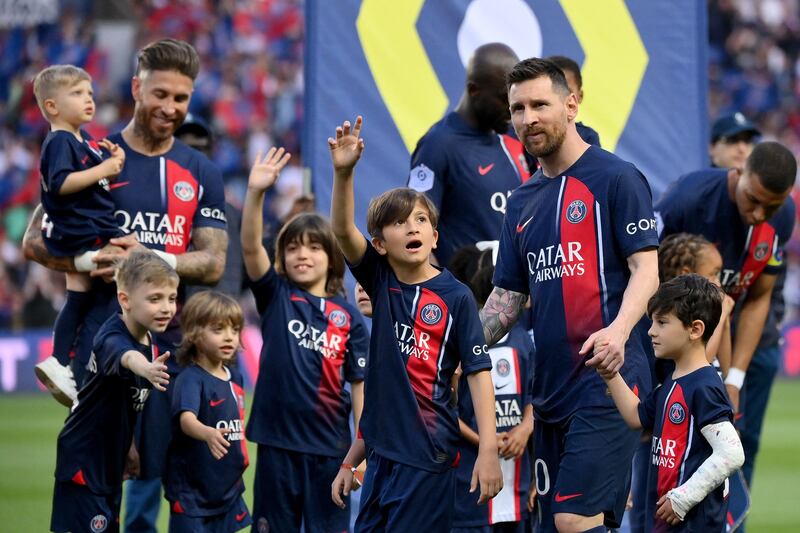 Sergio Ramos and Lionel Messi with their children before the game. AFP
