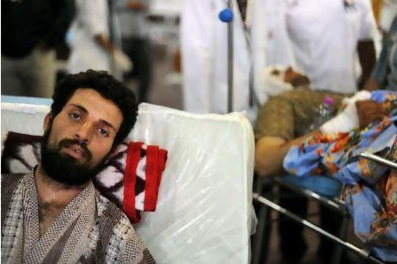A wounded man evacuated from the besieged Libyan city of Misrata waits for an ambulance inside a ship at the port of the rebel stronghold of Benghazi yesterday after the vessel carrying 800 migrants and civilian casualties from Misrata docked in the city.