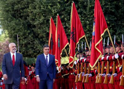 Albanian Prime Minister Edi Rama, left, inspects a guard of honor during a welcome ceremony in Tirana on  August 1. A British MP has called on Mr Rama to help stem the number of migrants coming from Albania. EPA