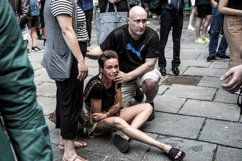A woman is comforted in front of the mall. Police received the first reports of a shooting at 5.37pm on Sunday, and arrested the suspect 11 minutes later. Reuters