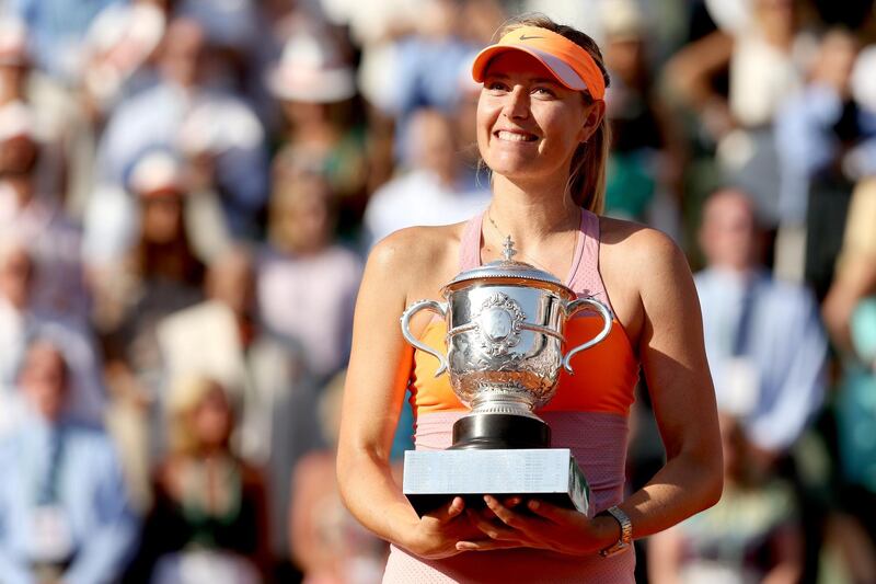 PARIS, FRANCE - JUNE 07:  Maria Sharapova of Russia poses with the Coupe Suzanne Lenglen trophy following her victory in her women's singles final match against Simona Halep of Romania on day fourteen of the French Open at Roland Garros on June 7, 2014 in Paris, France.  (Photo by Matthew Stockman/Getty Images)