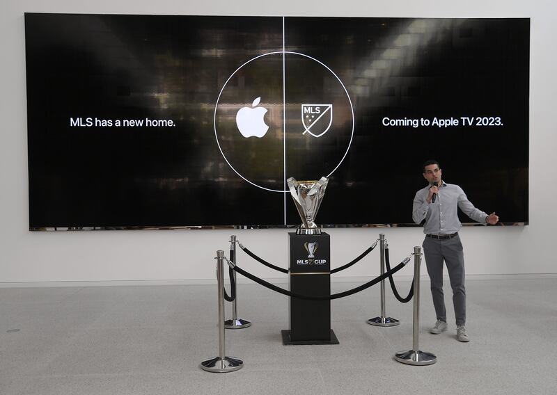 Former Philadelphia Union player Morgan Langley with the MLS Cup trophy at Apple's The Grove retail store in Los Angeles. The tech major recently struck a 10-year deal to air MLS games in a new subscription service, as well as Apple TV+ streaming platform. AFP