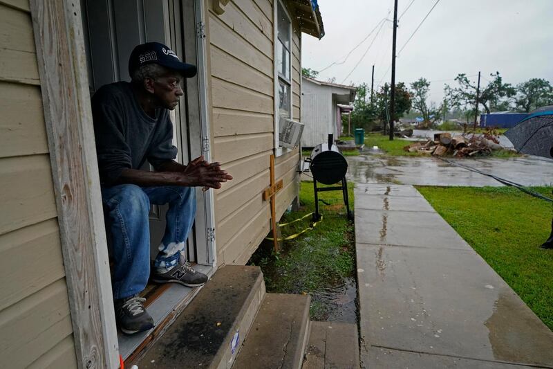 Earnst Jack, whose home was severely damaged during Hurricane Laura, sits in his front doorway as he waits for the arrival of Hurricane Delta in Lake Charles. AP