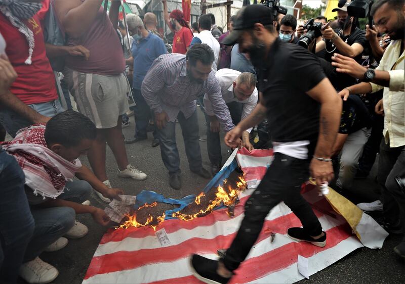 Protesters burn a US flag during a protest against the United States' interference in Lebanon's affairs, near the US embassy in Awkar area, Beirut, Lebanon.  EPA