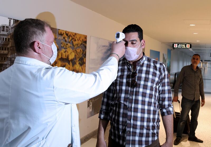 A Lebanese doctor checks the temperature of a passenger as a precautionary measure against the coronavirus, upon his arrival at the Rafic Hariri International Airport in Beirut. EPA