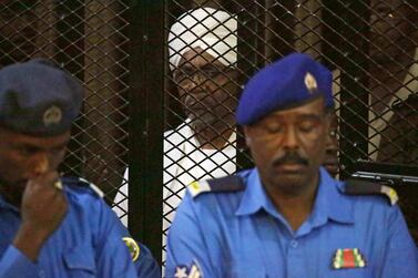 Sudan's ousted president Omar Al Bashir sits in the defendant's cage during his trial in Khartoum. EPA