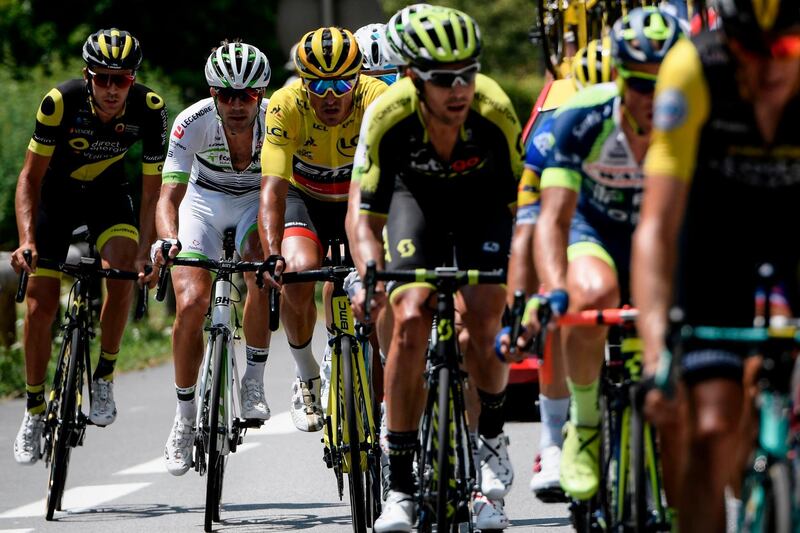 Belgium's Greg van Avermaet, third from left, wearing the overall leader's yellow jersey, rides in a breakaway group during the 10th stage of the Tour de France between Annecy and Le Grand-Bornand. Jeff Pachoud / AFP