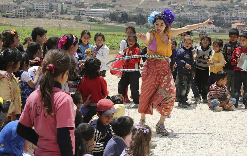 Members of Clowns Without Borders entertain Syrian refugee children in Jab Janine, Lebanon, on June 2. Sharif Karim / Reuters