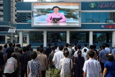 Residents watch a big video screen on Mirae Scientists Street in Pyongyang showing newsreader Ri Chun-Hee as she announces the news that the country has successfully tested a hydrogen bomb on September 3, 2017.
North Korea declared itself a thermonuclear power on September 3, after carrying out a sixth nuclear test more powerful than any it has previously detonated, presenting President Donald Trump with a potent challenge. / AFP PHOTO / KIM Won-Jin