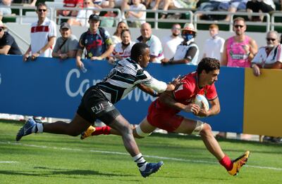 Players in action during the match between Fiji (black & White) vs Spain (red) on the second day of the Emirates Dubai Rugby Sevens. Pawan Singh/The National.