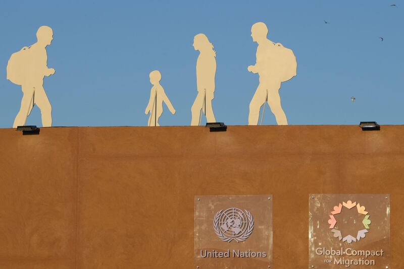 A picture taken on December 10, 2018 shows silhouettes of migrants installed at the grounds of the International conference on Global Compact for Migration in the Moroccan city of Marrakech. Politicians from around the globe gathered in Morocco for a major conference to endorse a United Nations migration pact, despite a string of withdrawals driven by anti-immigrant populism. The Global Compact for Safe, Orderly and Regular Migration was finalised at the UN in July after 18 months of talks and is due to be formally adopted with the bang of a gavel at the start of the two-day conference in Marrakesh.
 / AFP / FETHI BELAID
