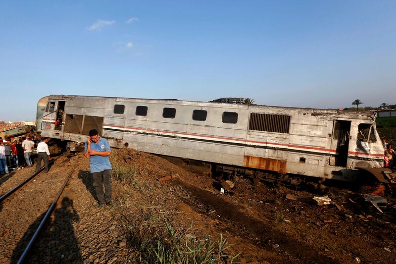 Onlookers gather at the scene of a train collision just outside Egypt’s Mediterranean port city of Alexandria. Ravy Shaker / AP Photo