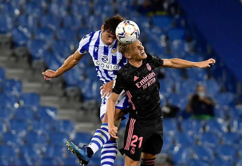 Martin Odegaard challenges for a header against Real Sociedad's Robin Le Normand. AP Photo