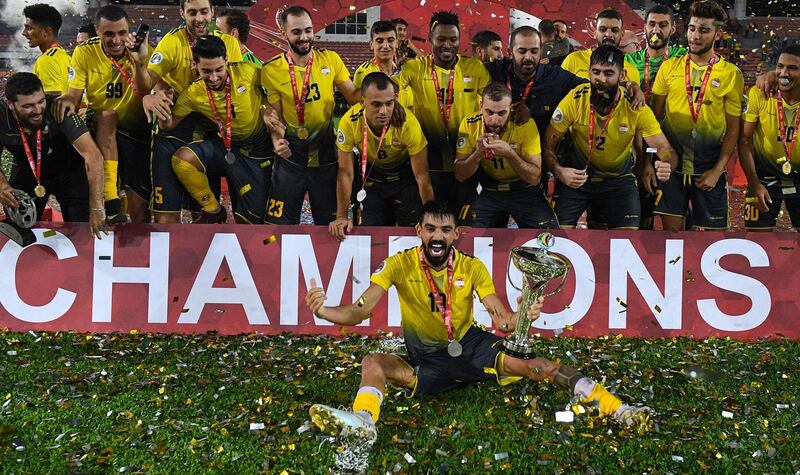 Al Ahed's players and coaching staff celebrate with the trophy after winning the 2019 AFC Cup Final with victory over North Korea's April 25 Sports Club at Kuala Lumpur Stadium. AFP