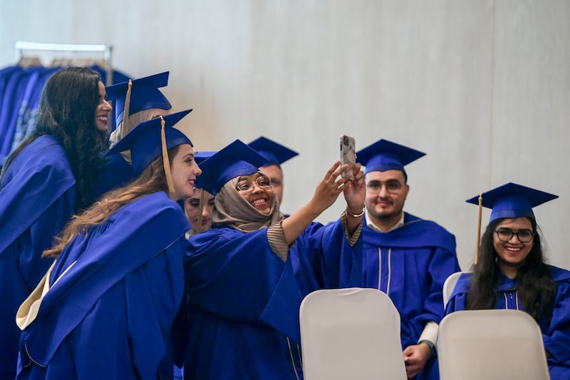 Students take photos before the Mohamed bin Zayed University of Artificial Intelligence's first graduation ceremony, in Abu Dhabi. The UAE’s development of a competitive education system is a continuing process. Khushnum Bhandari / The National